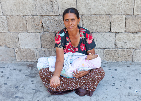 Mother and Baby beggar in the streets of Athens, Greece, with peopleのeditorial素材