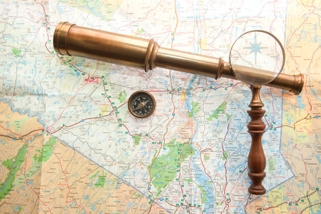 Arrangement of Map, Hand held Telescope, compass and magnifying glass