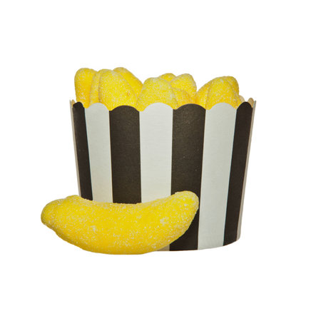 Banana flavour Jelly candies and a black and white paper cupの写真素材