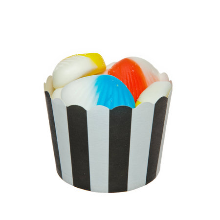 Shell shaped Jelly candies and a black and white paper cupの写真素材