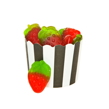 Strawberry flavour Jelly candies and a black and white paper cupの写真素材