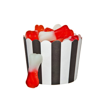 Bone shaped Jelly candies and a black and white paper cupの写真素材