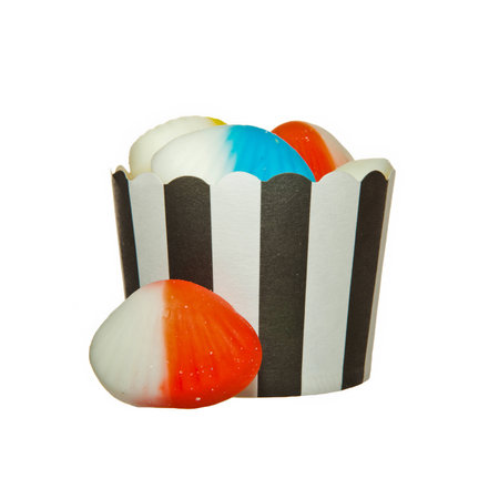 Shell shaped Jelly candies and a black and white paper cupの写真素材