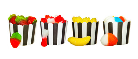 Arrangement of various  Jelly candies in black and white paper cupsの写真素材