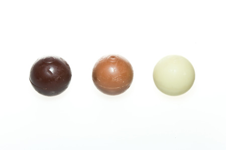 Three truffles - Dark brown and white chocolateの写真素材