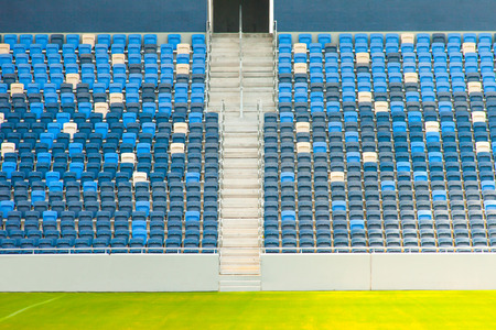 Stadium seats and green grassのeditorial素材