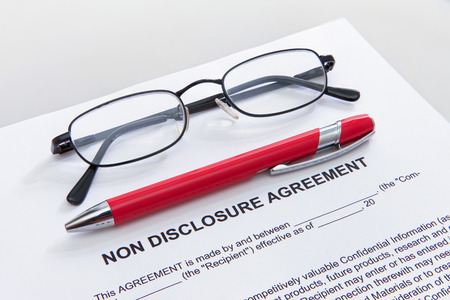 Non disclosure agreement with pen and glassesの写真素材