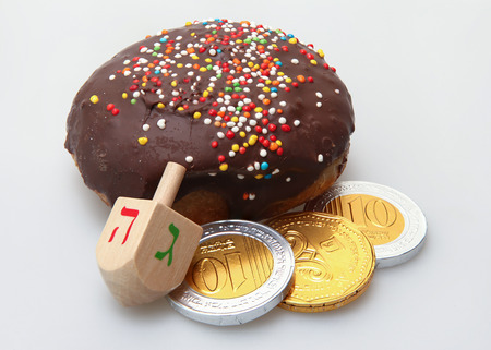 Hanukkah doughnut and spinning top - Traditional jewish holiday food and toy.の写真素材