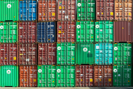 Various brands and colors of shipping containers stackedのeditorial素材