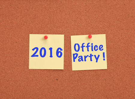 Cork board with 2016 office party written on two yellow notes
