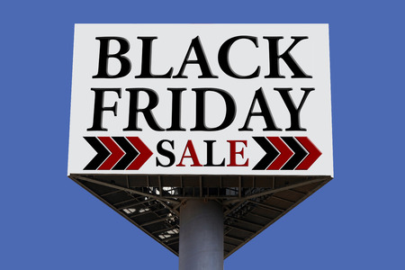 Black Friday sale billboard with blue skyの写真素材