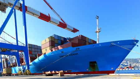 International Mega Container ship unloading containers on service trucks