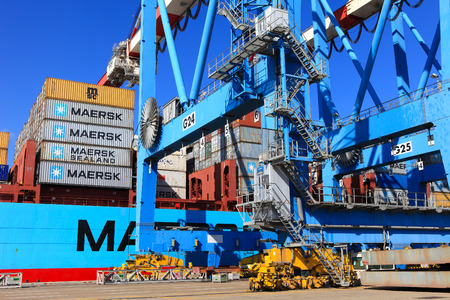 International Mega Container ship unloading containers on service trucksのeditorial素材