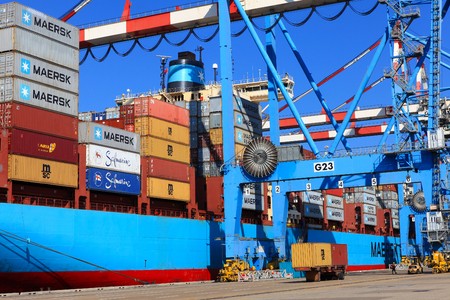 International Mega Container ship unloading containers on service trucks