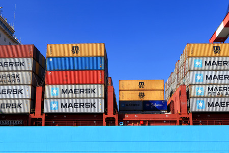 International Mega Container ship unloading containers on service trucksのeditorial素材