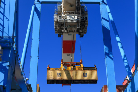 International Mega Container ship unloading containers on service trucksのeditorial素材