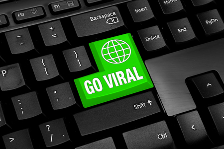 Black Computer keyboard with green go viral buttonの写真素材