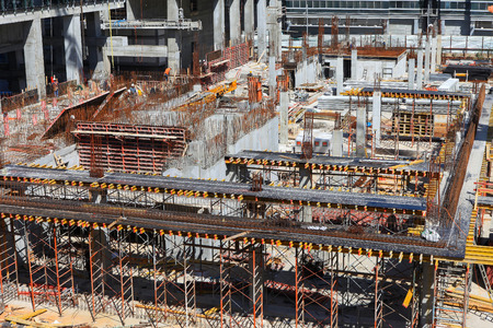 New skyscraper Construction site with workers at the business center of downtown Tel Aviv.