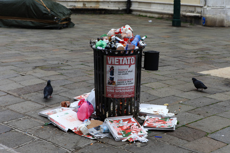 Typical Venetian trash container near Piazza San Marco, with empty pizza boxes on the ground