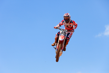 Motocross rider and bike clearing a tabletop jump during the final heat of the raceのeditorial素材