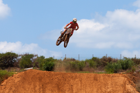 Motocross rider and bike clearing a tabletop jump during the final heat of the raceのeditorial素材