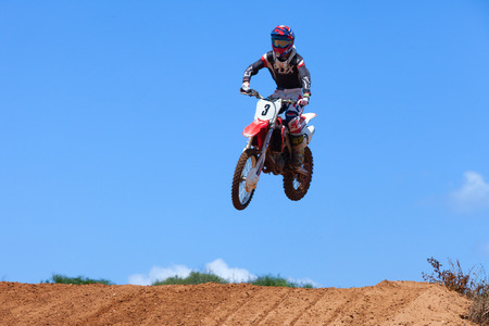 Motocross rider and bike clearing a tabletop jump during the final heat of the raceのeditorial素材