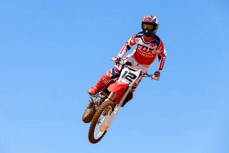 Motocross rider and bike clearing a tabletop jump during the final heat of the raceのeditorial素材