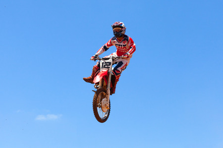 Motocross rider and bike clearing a tabletop jump during the final heat of the raceのeditorial素材
