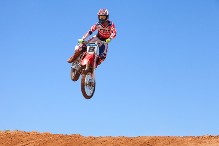Motocross rider and bike clearing a tabletop jump during the final heat of the raceのeditorial素材