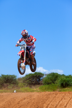 Motocross rider and bike clearing a tabletop jump during the final heat of the race.のeditorial素材