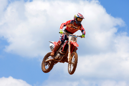 Motocross rider and bike clearing a tabletop jump during the final heat of the race.のeditorial素材