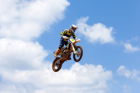 Motocross rider and bike clearing a tabletop jump during the final heat of the race.のeditorial素材