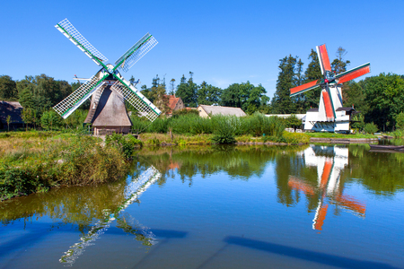 Classic Dutch windmills in nature with blue sky in the backgroundの写真素材