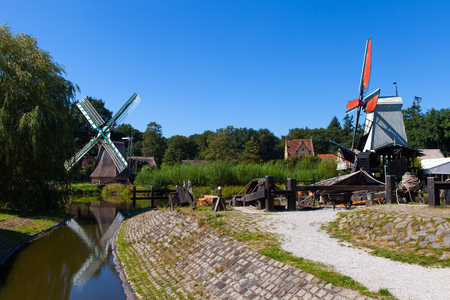 Classic Dutch windmills in nature with blue sky in the backgroundの写真素材