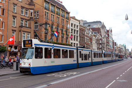Tram (rail vehicle which runs on tracks along public urban streets) next to dam square, Amsterdam, The Netherlandsのeditorial素材
