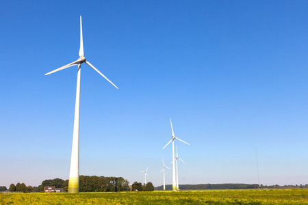 Wind turbine spinning with in a green countryside environmentの写真素材