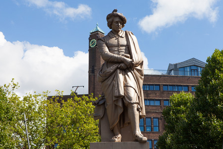 Sculpture of the dutch painter Rembrandt with and installation of Night watch sculptures on a sunny day in Amsterdamの写真素材