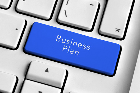 White keyboard with blue business plan buttonの写真素材