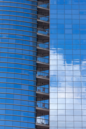 Modern skyscrapers with window reflections of blue skyの写真素材