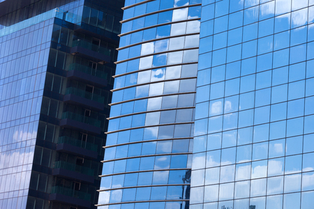 Modern skyscrapers with window reflections of blue skyの写真素材