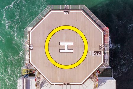 Top down aerial view of a Helicopter deck on a large Supply ship.
