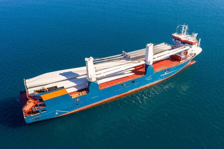 Heavy load carrier ship loaded with Electric Turbine Blades anchored at Sea, Aerial view.の写真素材