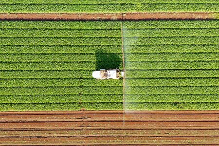 Pesticide Sprayer Tractor working on a large field.の写真素材