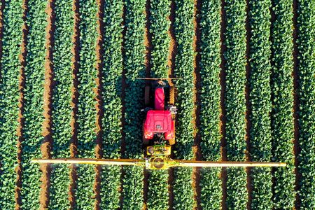 Pesticide Sprayer Tractor working on a large field.の写真素材