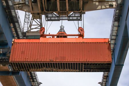Crane moving a Shipping Container to a storage platform.の写真素材