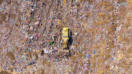 Yellow Landfill compactor at Municipal Solid waste compound.の写真素材