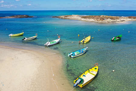 Small Fishing Boats anchored in a shallow lagoon, Aerial image.の写真素材