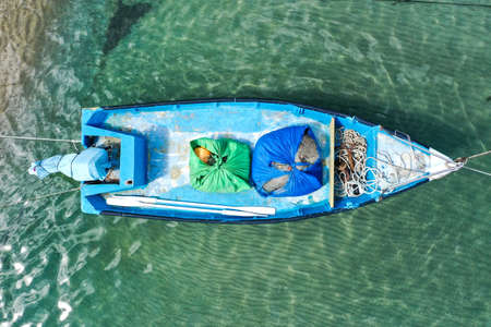 Small Fishing Boat anchored in a shallow lagoon.の写真素材