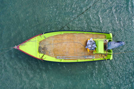 Small Fishing Boat anchored in a shallow lagoon.の写真素材