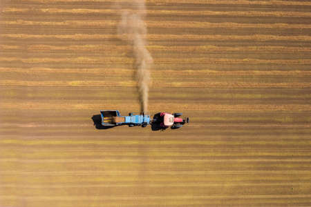 Almond picker harvester processing a field, Aerial view.の写真素材